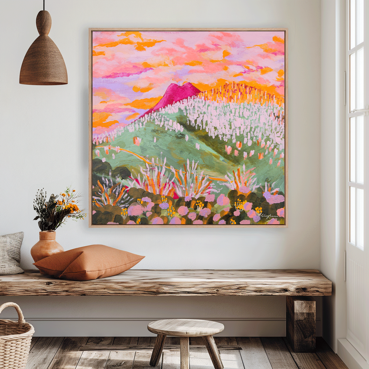 A floating framed fine art print of an original landscape artwork painting of the Grey Mare range and Mount Jagungal in Kosciuszko National Park hanging on a wall inside an interior created by Lizzy Ann Art.
